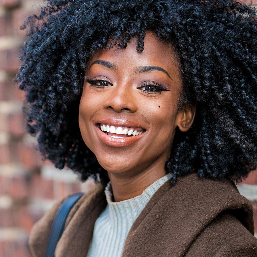 woman smiling after getting her braces removed